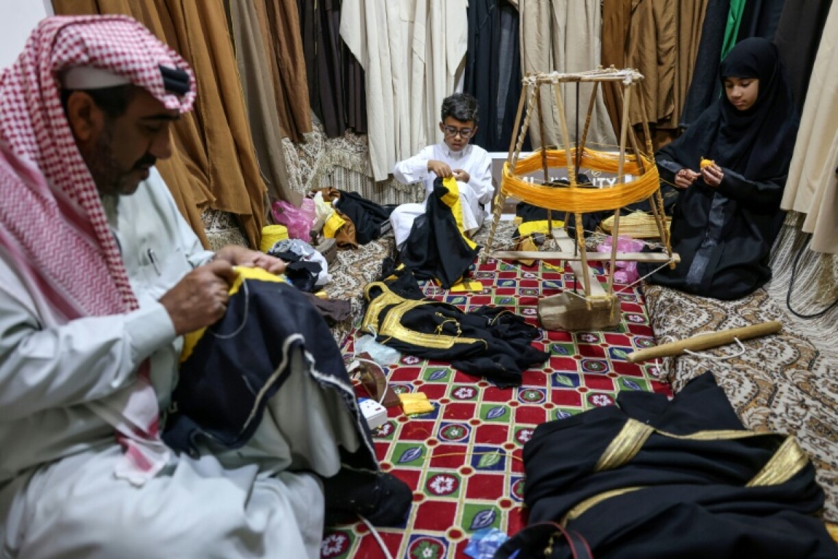 Under Mohammed's watchful eye, his grandson Ghassan, 10, and granddaughter Fajr, nine, learn to embroider the delicate gowns.