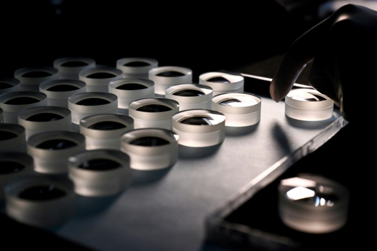 An employee prepares a lens at the Leica factory in Wetzlar, western Germany