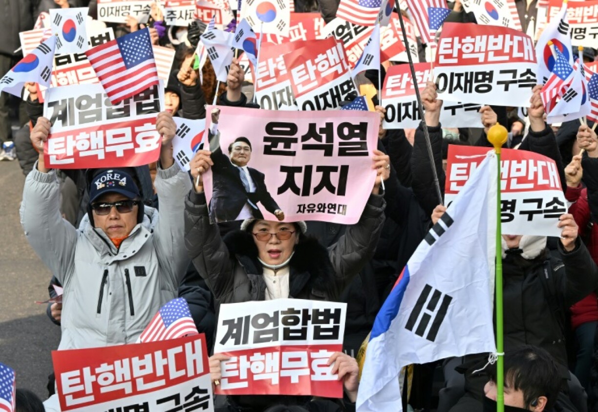 Supporters of impeached South Korean President Yoon Suk Yeol hold placards during a protest in Seoul