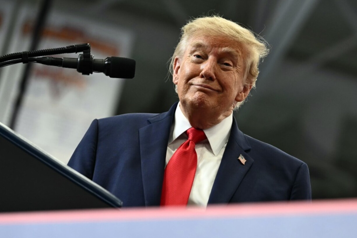 US President Donald Trump smiles as he finishes a speach in a hockey rink converted into a rally venue in Wasilla, Alaska