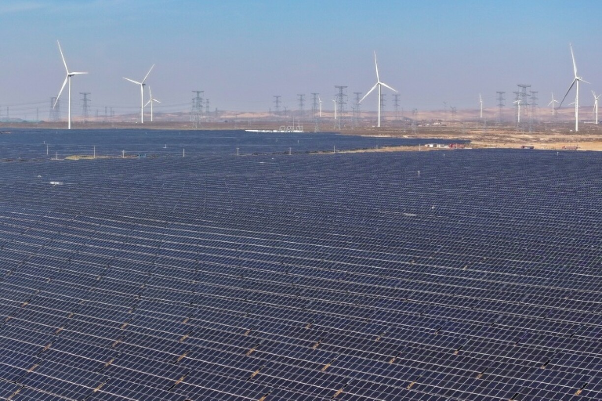 Wind turbines and solar panels -- key to the world's geen energy transition -- are seen at a solar photovoltaic farm in Lingwu in China's northern Ningxia region
