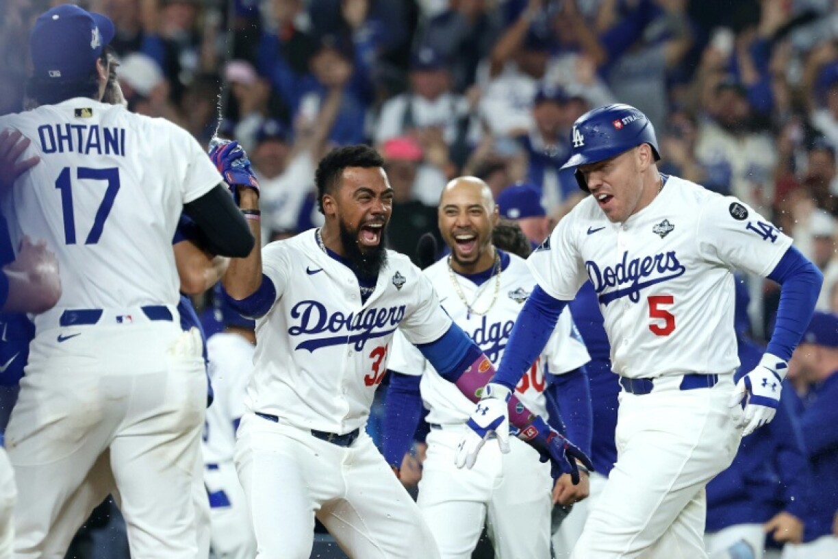 Freddie Freeman, right, of the Los Angeles Dodgers is congratulated by teammates after hitting a walk-off home run in the 18th inning to lift his team over the Toronto Blue Jays in game three of the World Series