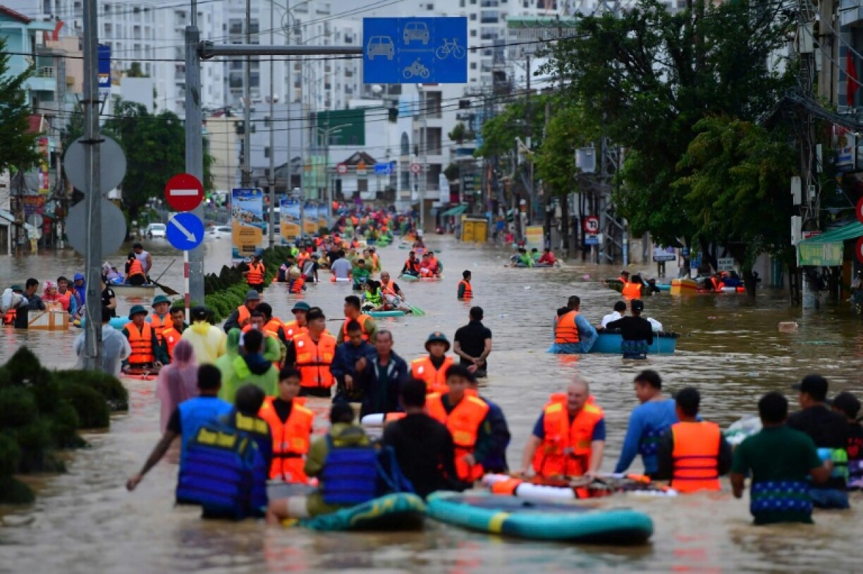 People wade through floodwaters in Vietnam's coastal Nha Trang city