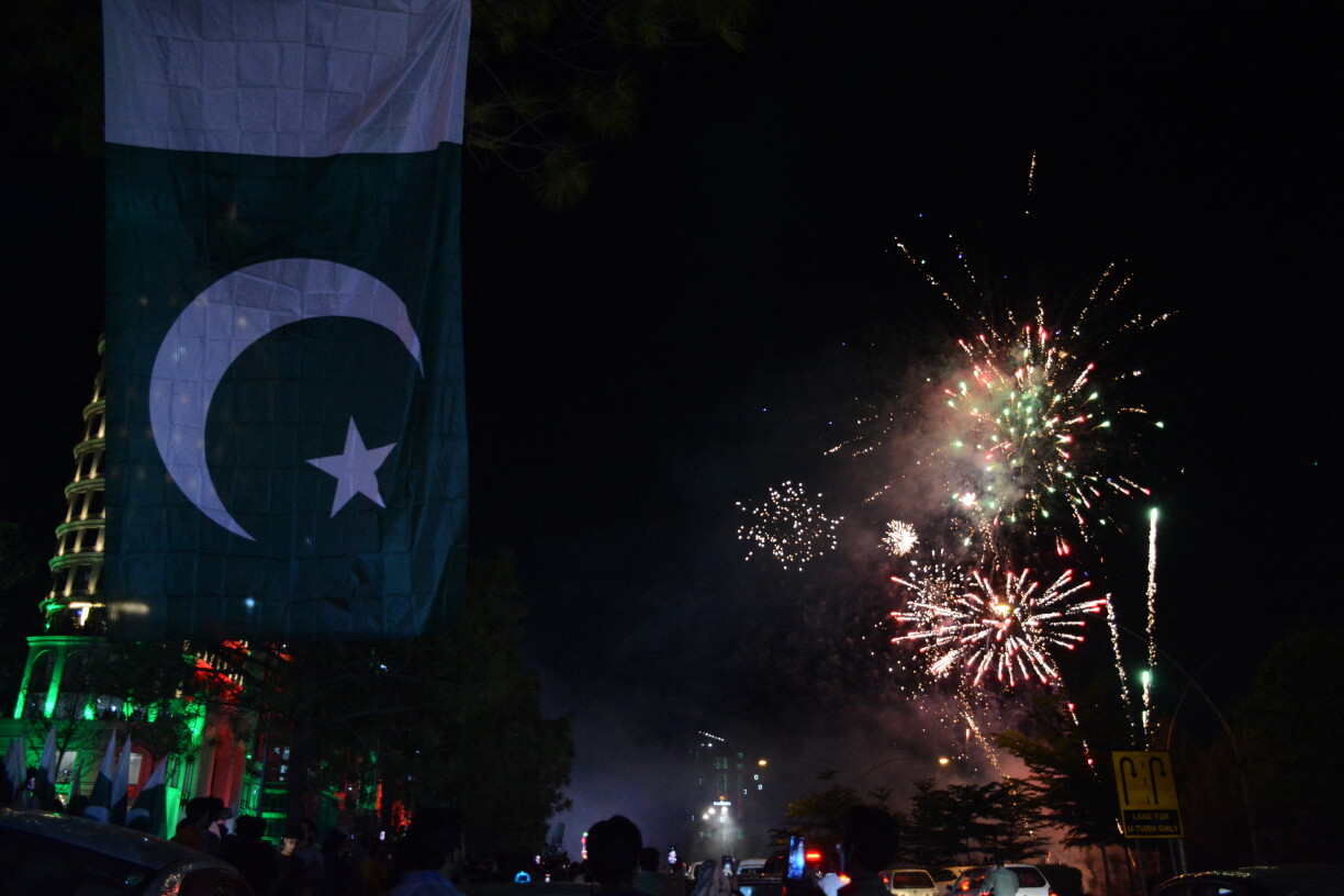 People watch fireworks in the sky during celebrations following the signing of the Makkah Joint Defence Agreement between Pakistan, Saudi Arabia, and Turkey in front of the new blue area in Islamabad, Pakistan, on 9 August 2026.
