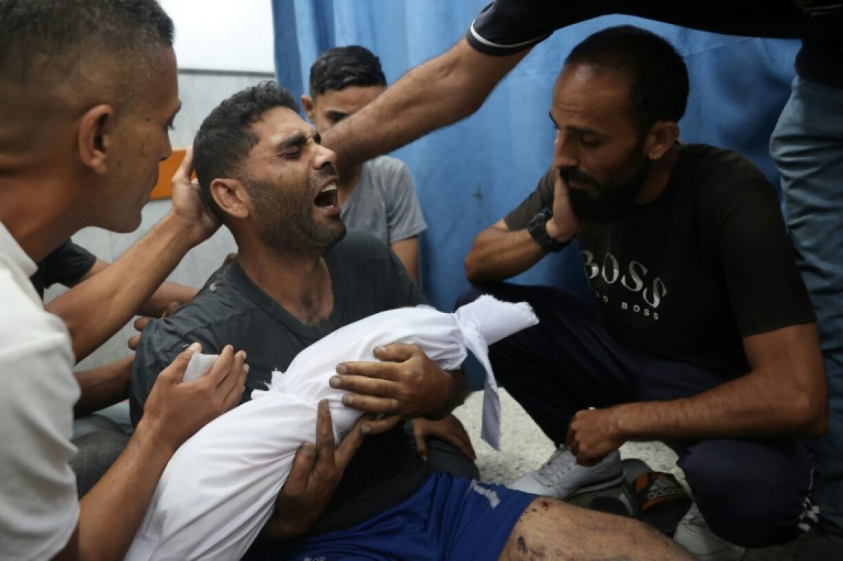 A Palestinian man mourns his 6-month-old son, killed in a reported Israeli strike on Gaza City