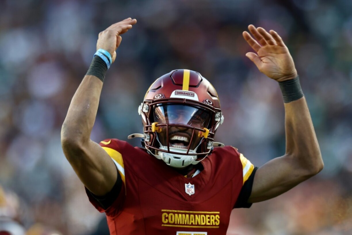 Washington quarterback Jayden Daniels celebrates a touchdown pass in the Commanders' NFL victory over the Philadelphia Eagles
