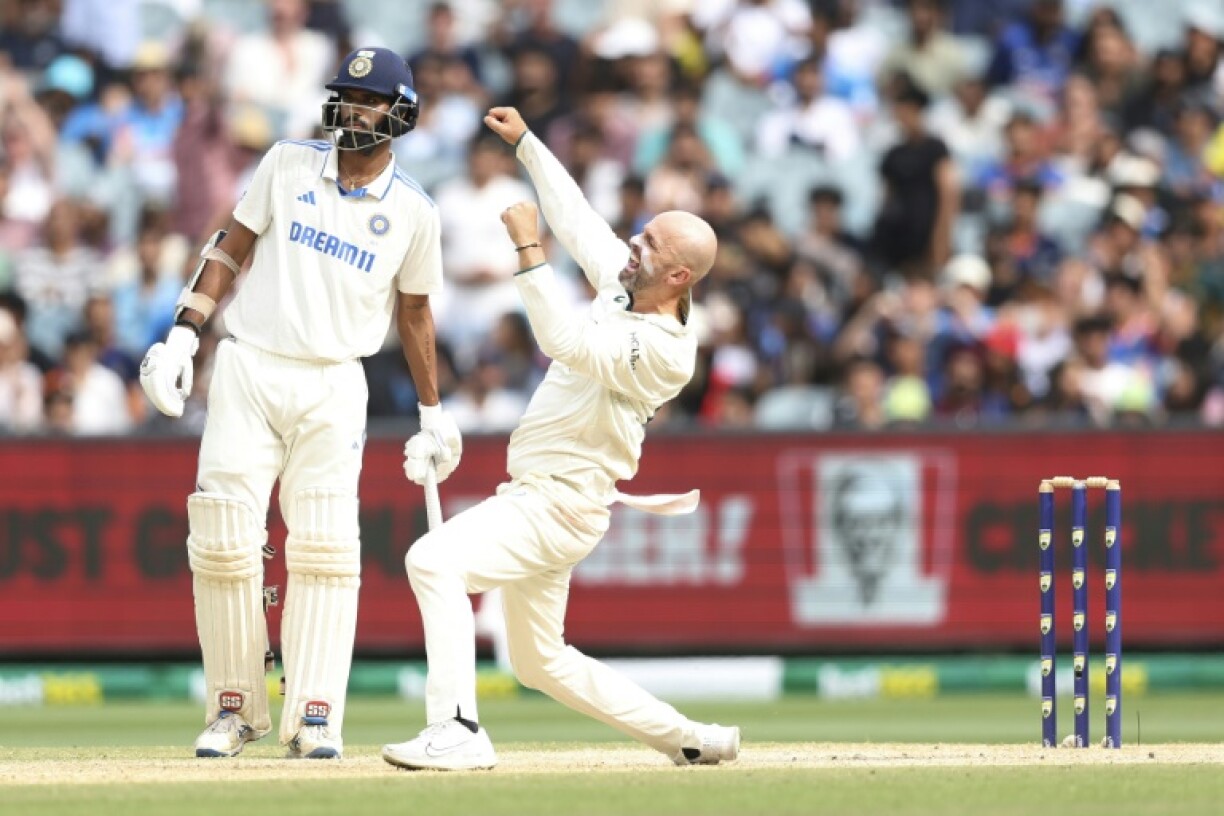 Australia's Nathan Lyon celebrates taking the final wicket of India's Mohammed Siraj to win the fourth Test