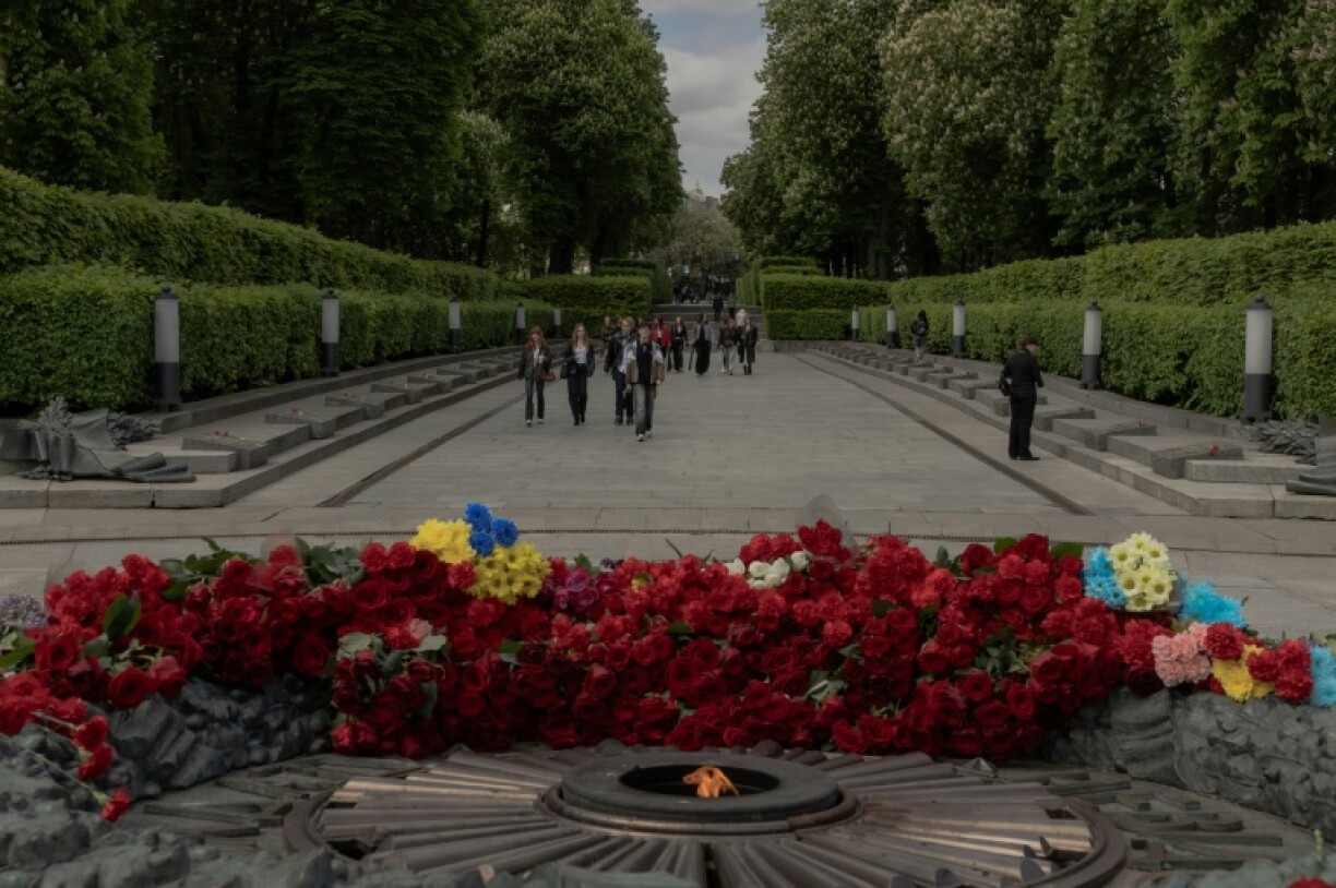 People walk past the Tomb of the Unknown Soldier at the World War II memorial on the Day of Remembrance and Victory over Nazism in Kyiv