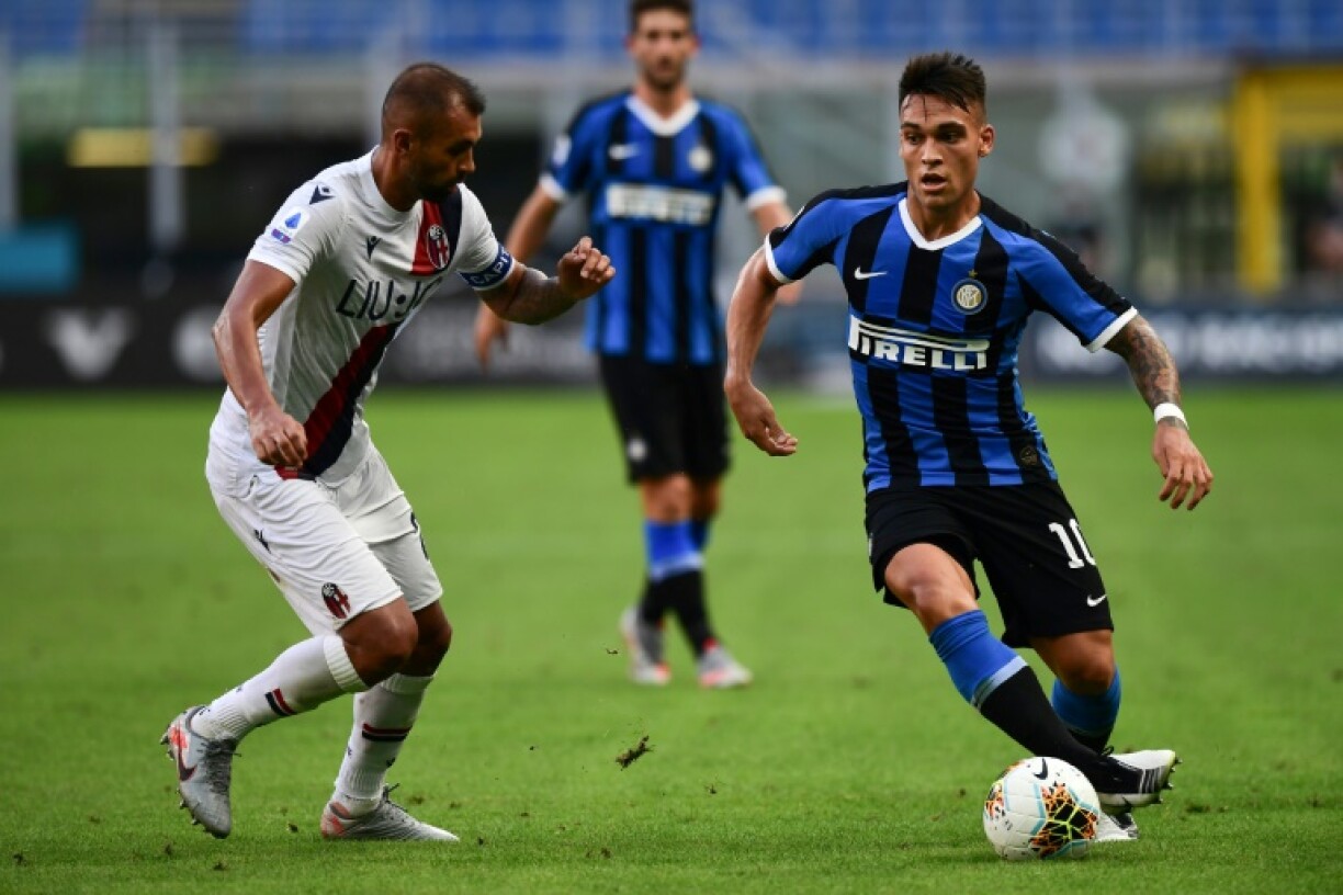 L'attaquant argentin de l'Inter Milan, Lautaro Martinez (d), aux prises avec le défenseur brésilien de Bologne, Danilo, lors du match de Serie A, à Milan, le 5 juillet 2020