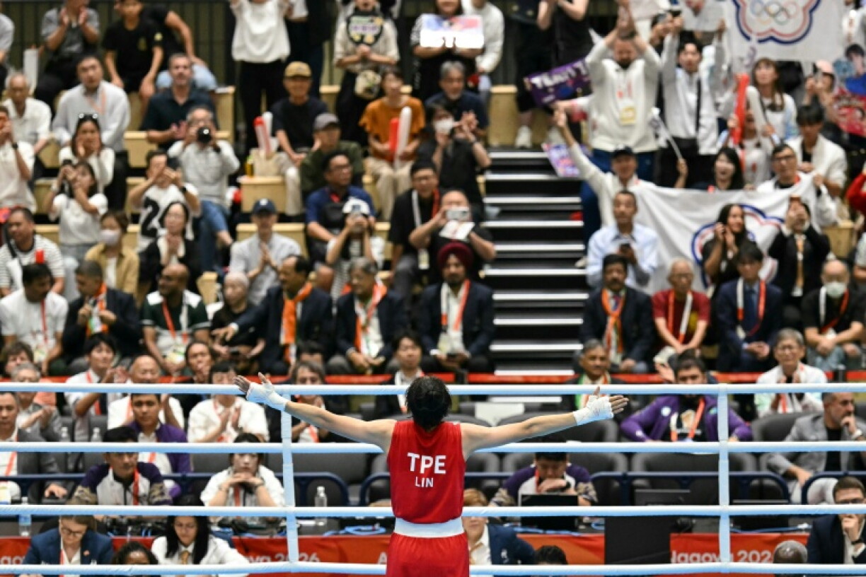 Taiwan's Lin Yu-ting celebrates her victory against China's Yang Chengyu in front of small band of Taiwanese fans