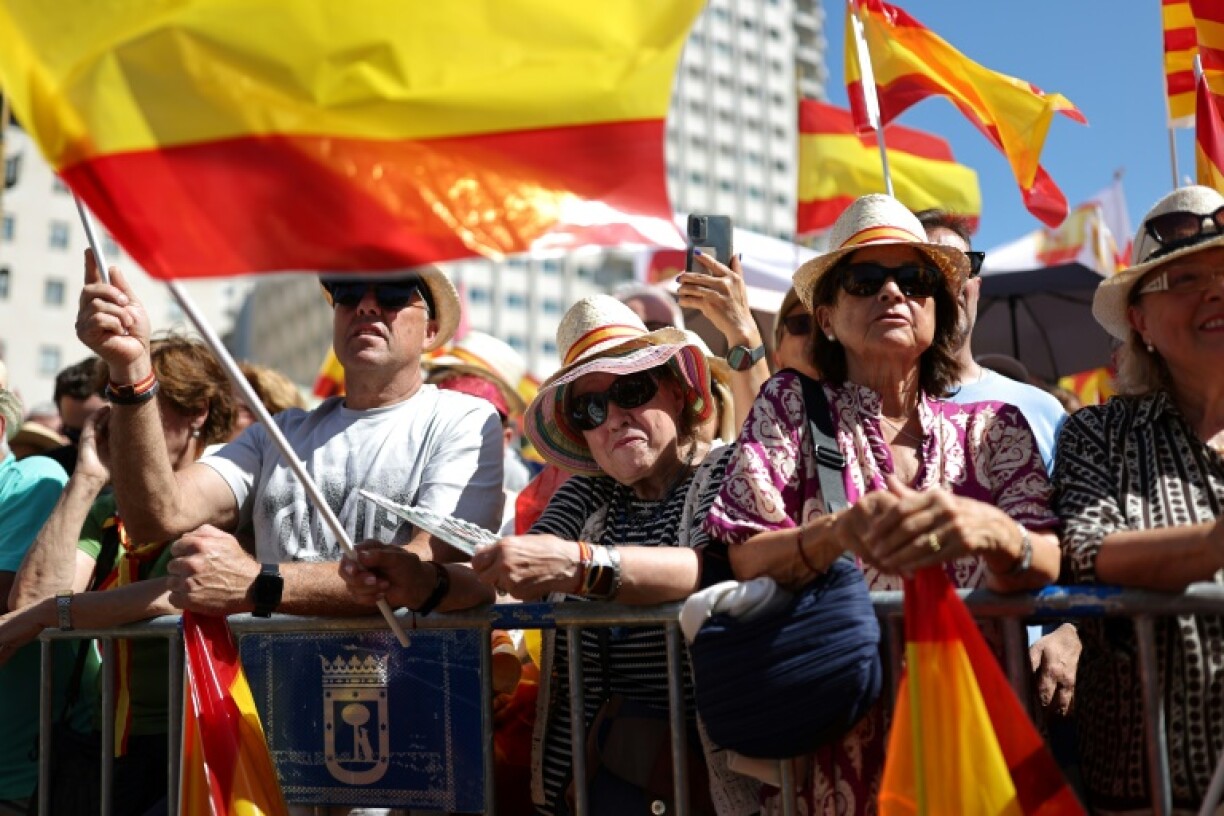 Protesters, many waving red and yellow Spanish flags, massed in central Madrid and chanted “Pedro Sanchez, resign!”