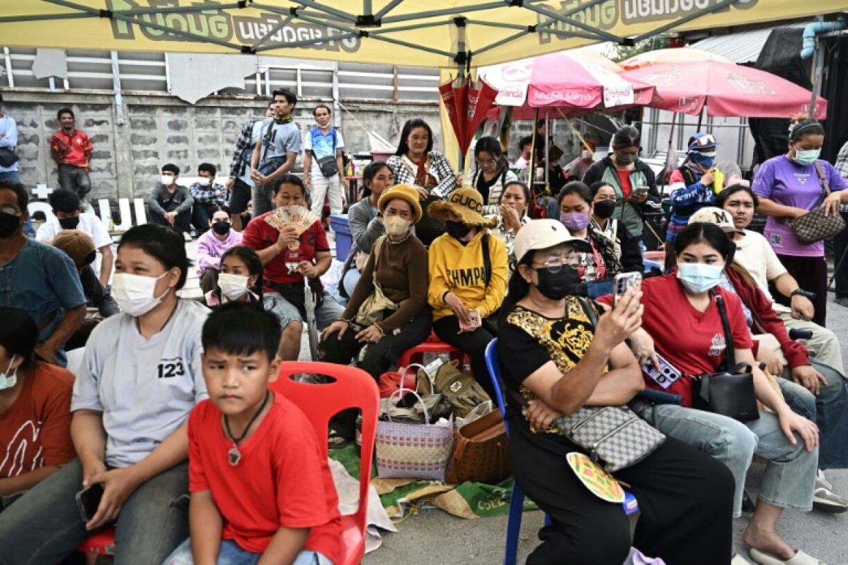 People wait for news of their missing family and friends at the site of an under-construction building collapse in Bangkok days after an earthquake struck in neighbouring Myanmar