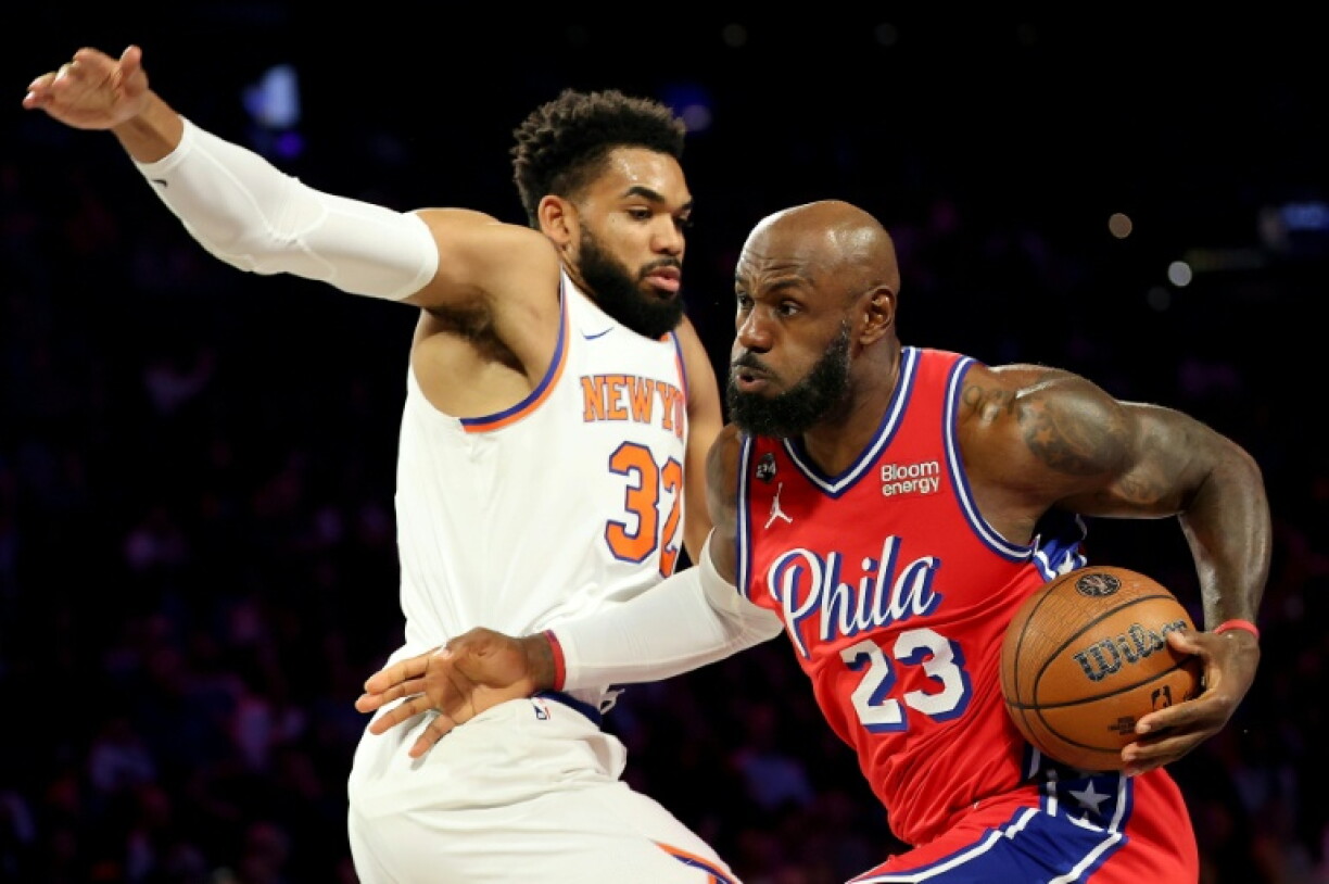 Philadelphia's LeBron James drives against Karl-Anthony Towns in the 76ers' NBA Cup group stage victory over the New York Knicks