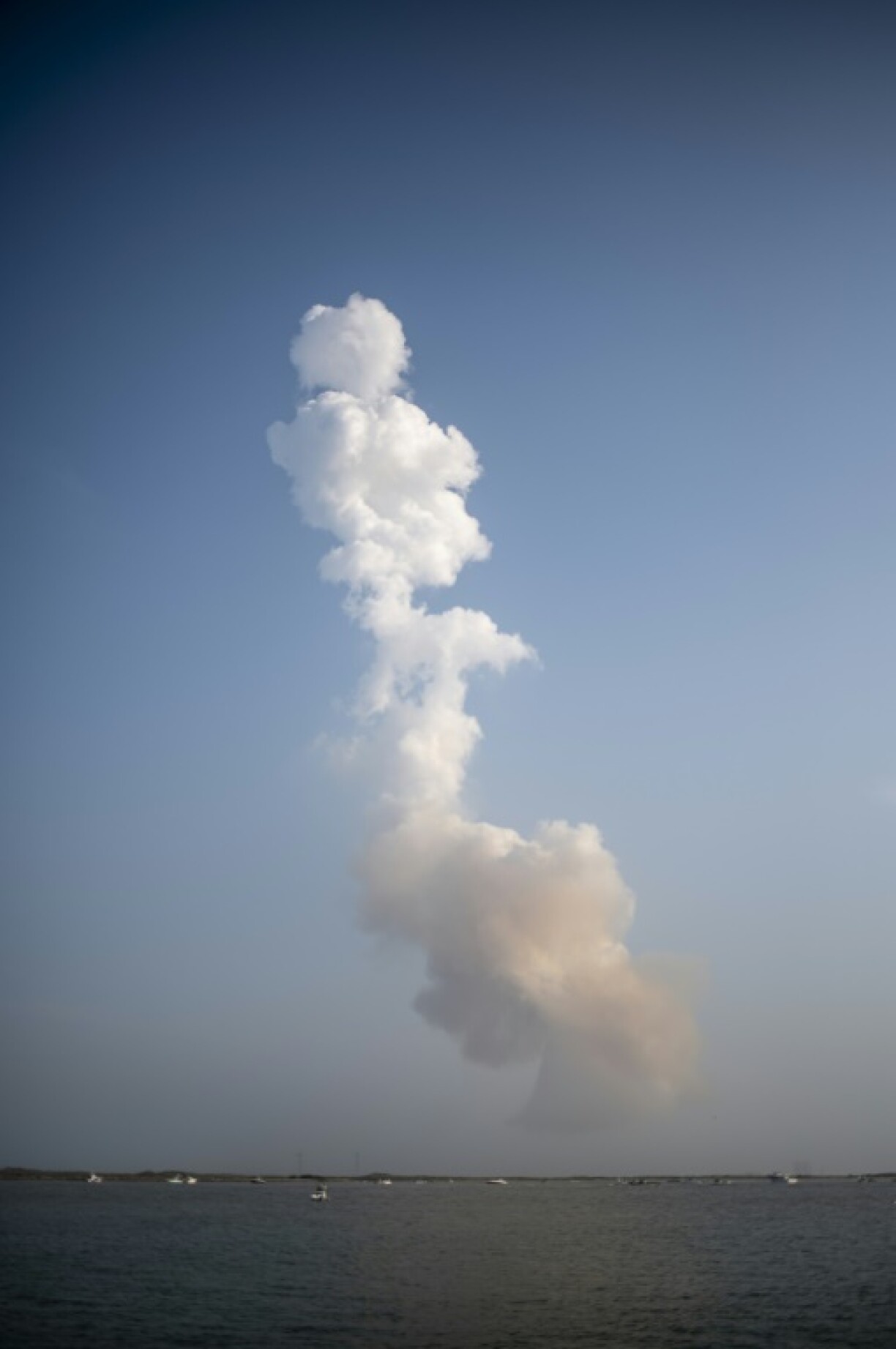 A plume of exhaust from the rocket boosters is left behind after the SpaceX Starship rocket launched from Starbase, Texas, as seen from South Padre Island on May 27, 2025