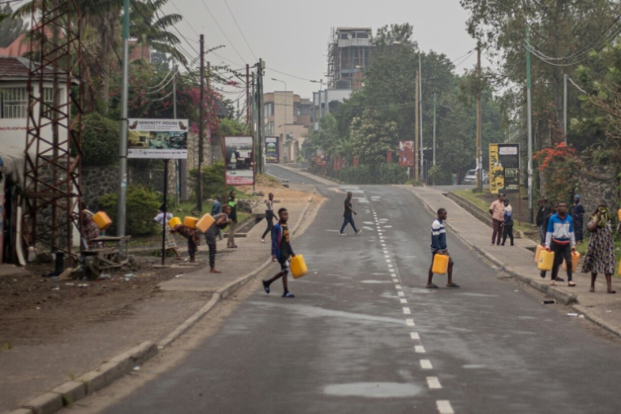 Residents look to fetch water from Lake Kivu as fighting subsided after a third day of clashes between Congolese troops and fighters from the M23 armed group backed by the Rwandan army