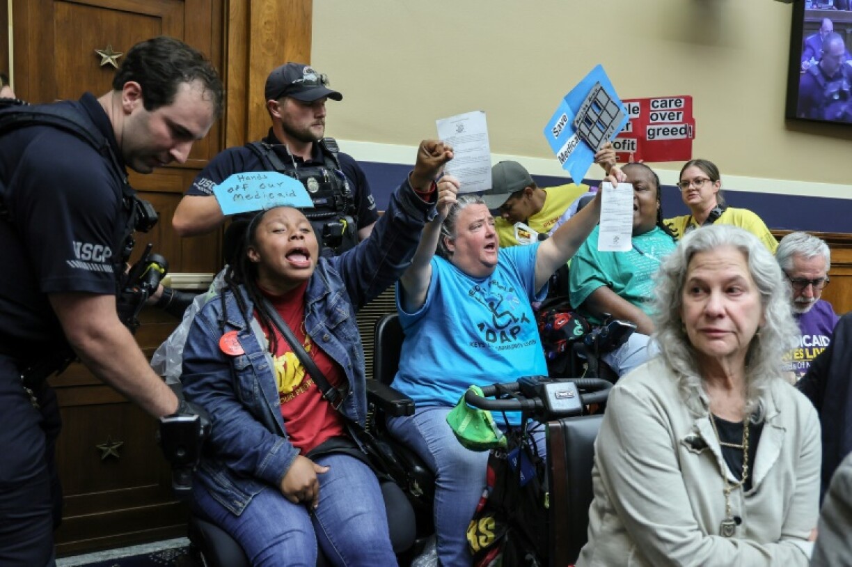 US Capitol Police remove a wheel-chair bound protestor from a House Energy And Commerce Committee session in Washington