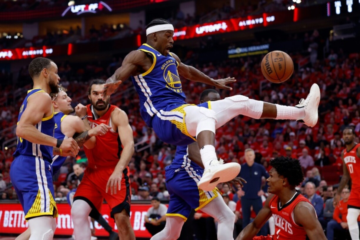 Golden State's Jimmy Butler, center, suffered a pelvic bruise after an awkward landing on this play after being fouled by Houston's Amen Thompson