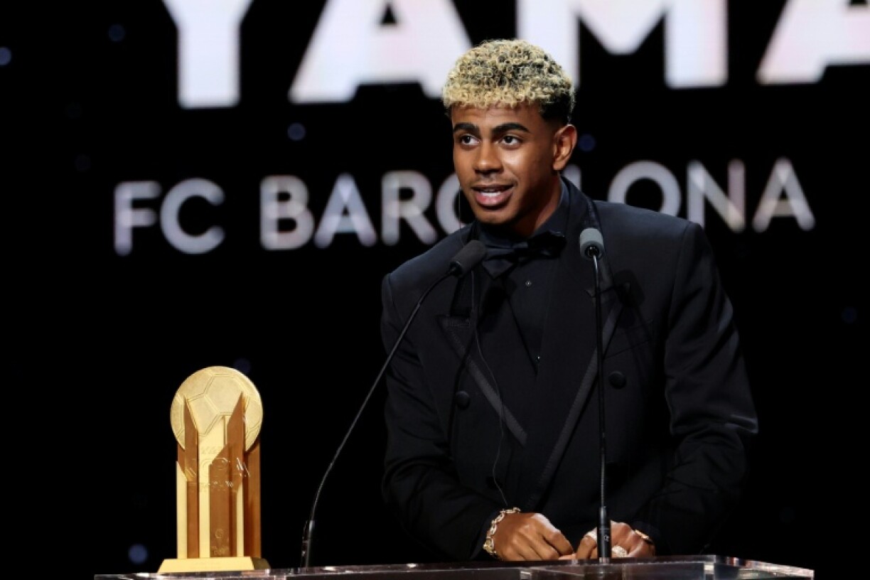Barcelona's Spanish forward Lamine Yamal speaks after receiving the Kopa Trophy for the best under-21 player at the Ballon d'Or ceremony