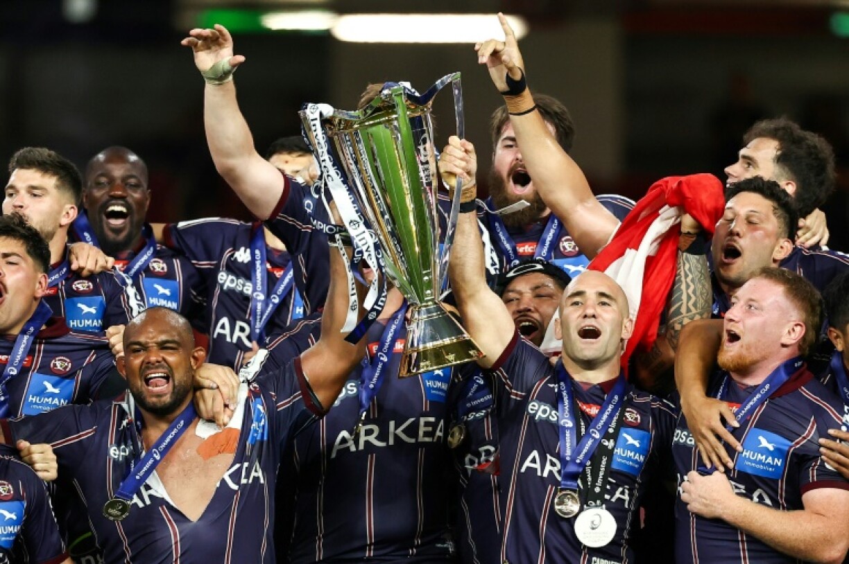 Jefferson Poirot (L) and Maxime Lucu (R) lift the Champions Cup trophy last month