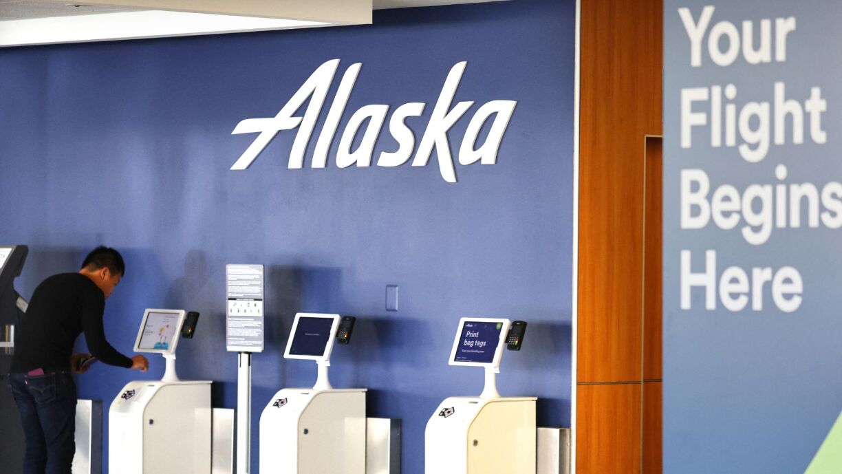 The Alaska Airlines logo is displayed at a check-in area at Los Angeles International Airport (LAX) on 4 December 2023 in Los Angeles, California.