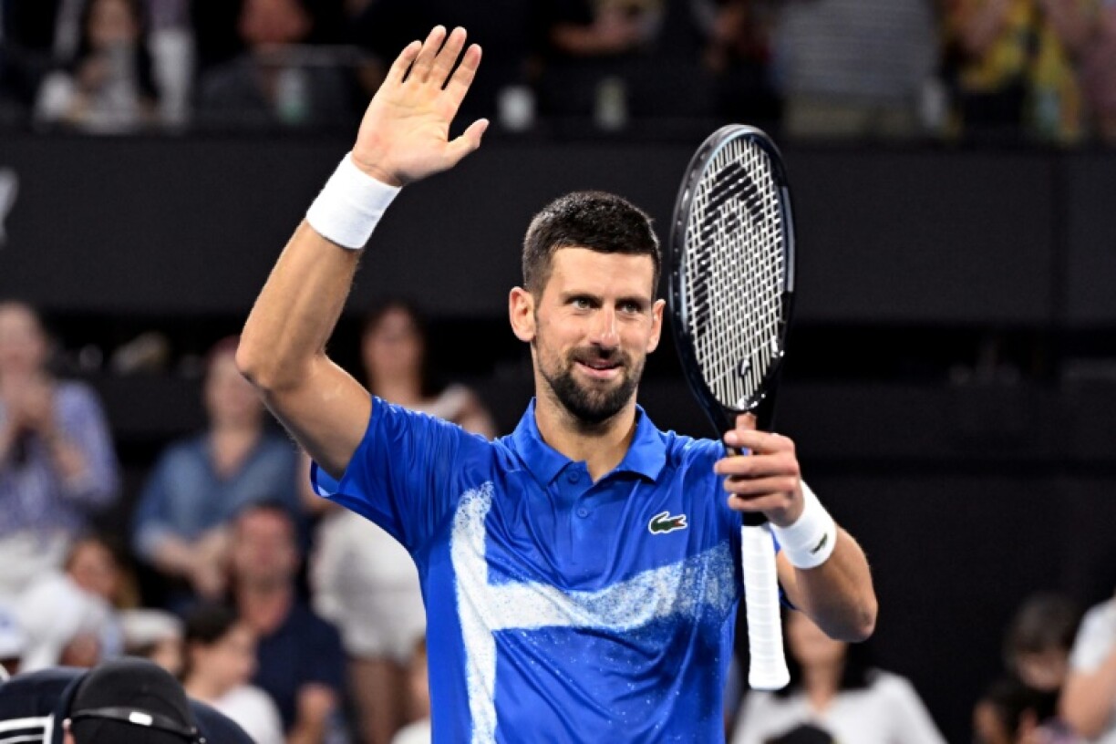 Novak Djokovic celebrates defeating Gael Monfils in Brisbane