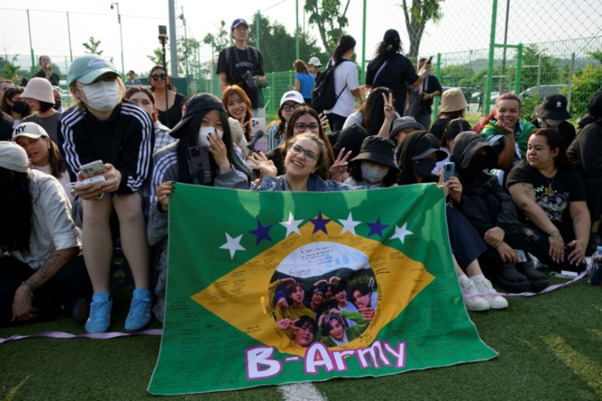 Fans of K-pop boy band BTS gathered at a football field near the army bases where singers RM and V were discharged