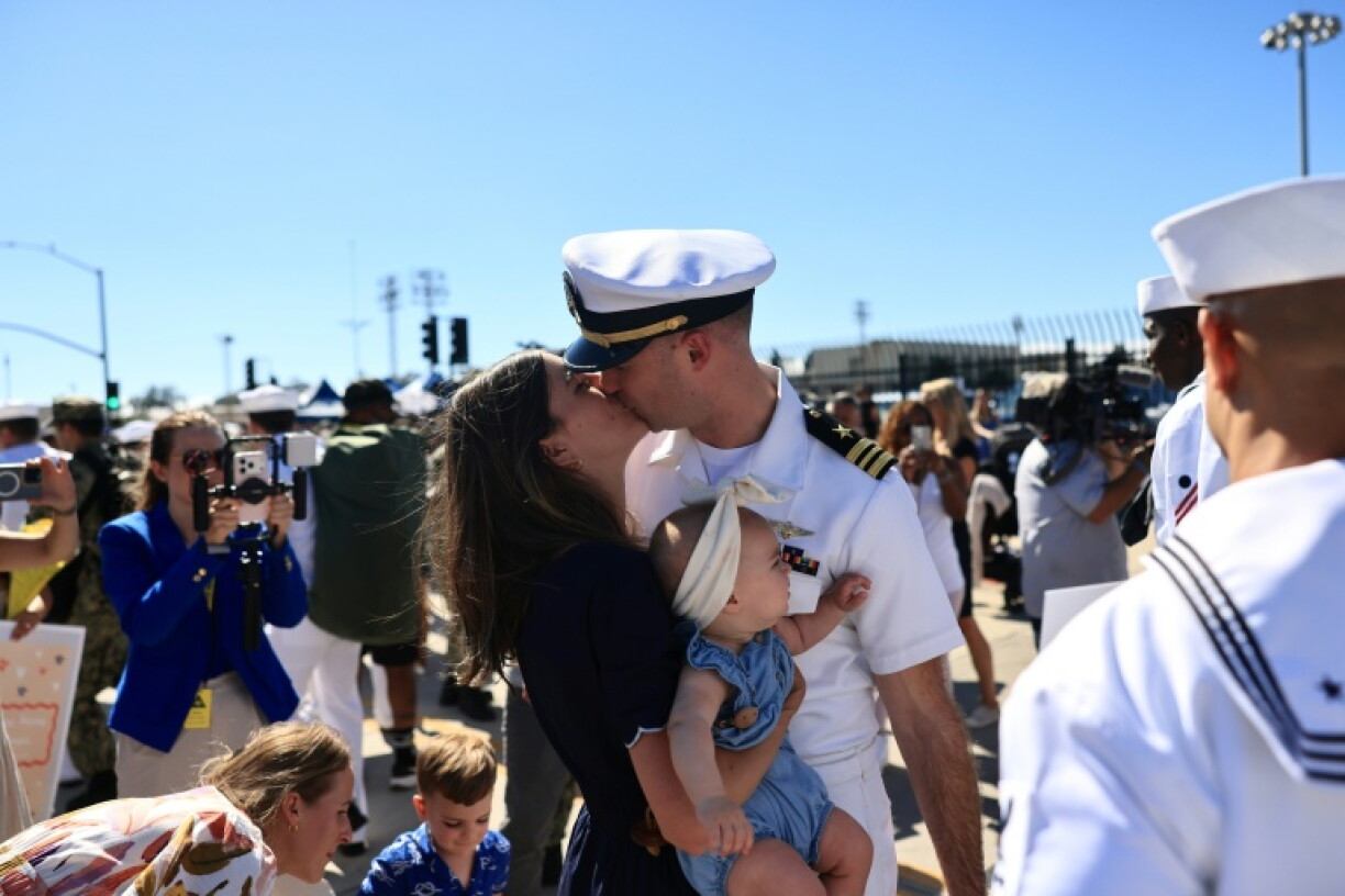 More than 100 new dads stepped ashore in San Diego to meet babies that were not born when they left port almost a year ago.