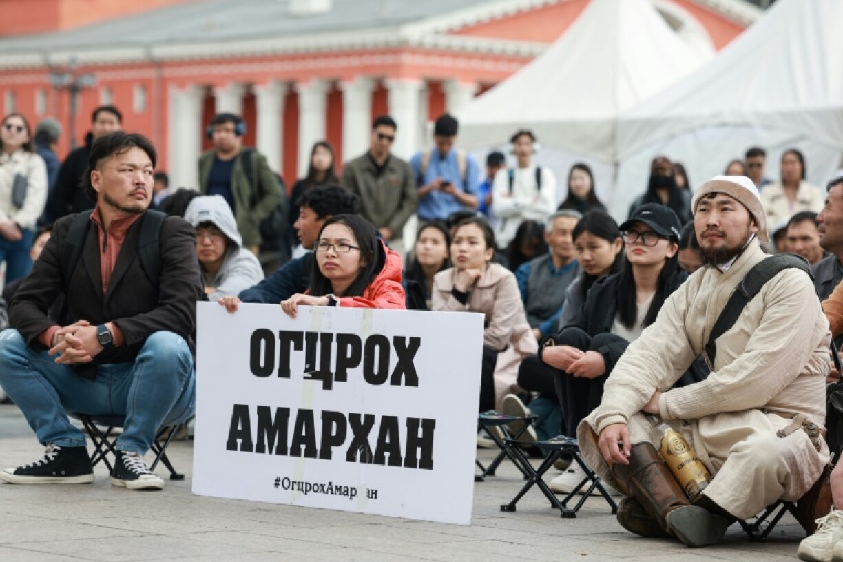 A placard reading 'It's easy to resign' is held during a protest calling for the resignation of Prime Minister Luvsannamsrain Oyun-Erdene