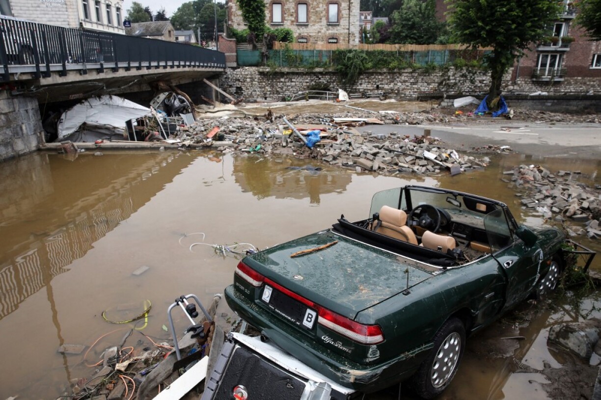 This picture shows a damaged car and rubble caused by the floods in Theux, near Liege, on July 16, 2021