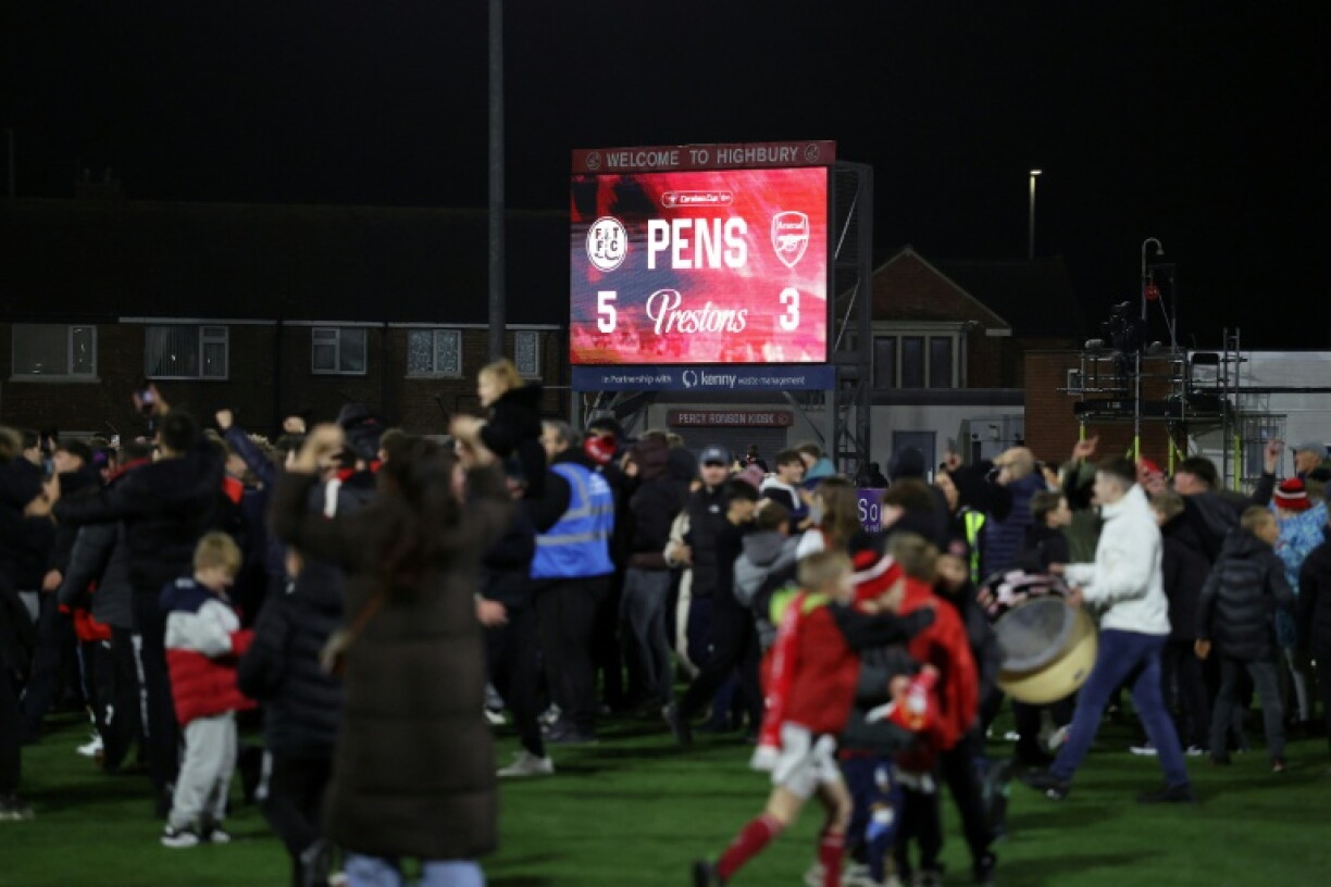 Fleetwood fans invade the pitch as they celebrate their team's penalty shootout win over Arsenal in the fourth round of the English League Cup