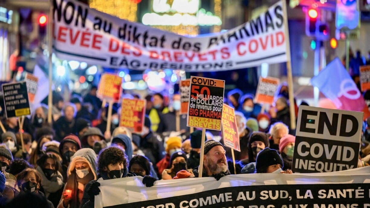 Activists hold placards during a protest in favour of an agreement to waive patent protections for Covid-19 vaccines on November 30, 2021 in Geneva. The suspension of the intellectual property rights for Covid-19 vaccines was a main topic of the cancelled World Trade Organization (WTO) ministerial meeting.
