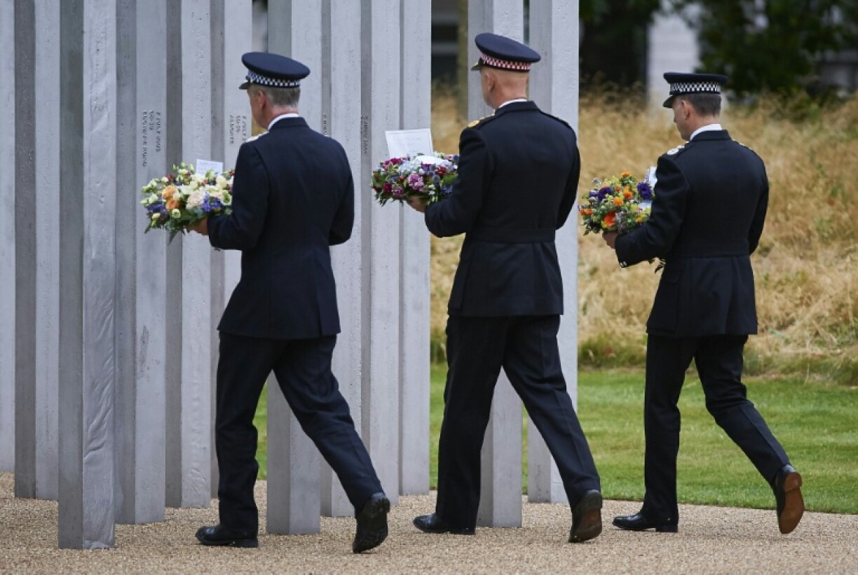 Police officers lay wreaths at the memorial to the July 7 victims in London's Hyde Park