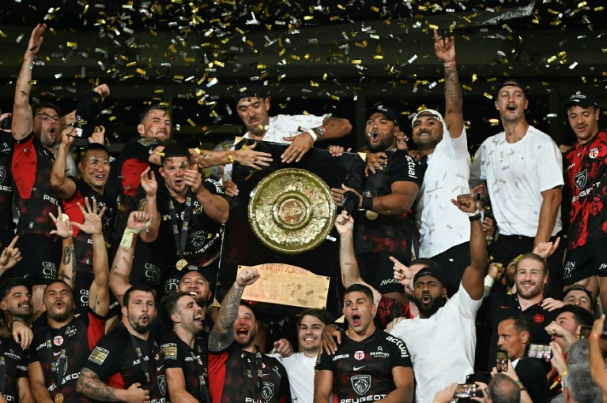 Toulouse players celebrate with the Top 14 trophy