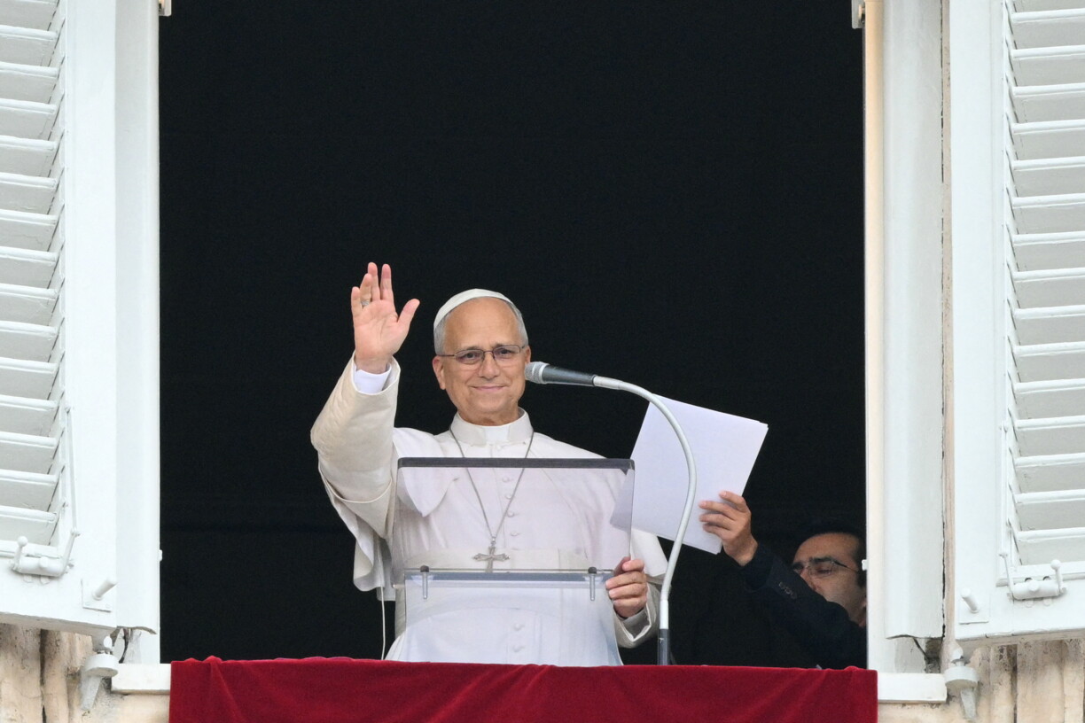 Pope Leo XIV waves from the window of the apostolic palace overlooking St. Peter's square during the Angelus prayer a day after his return to The Vatican following a surgery to remove a cancerous tumour in his right lung, on October 18, 2026. (Photo by Tiziana FABI / AFP)