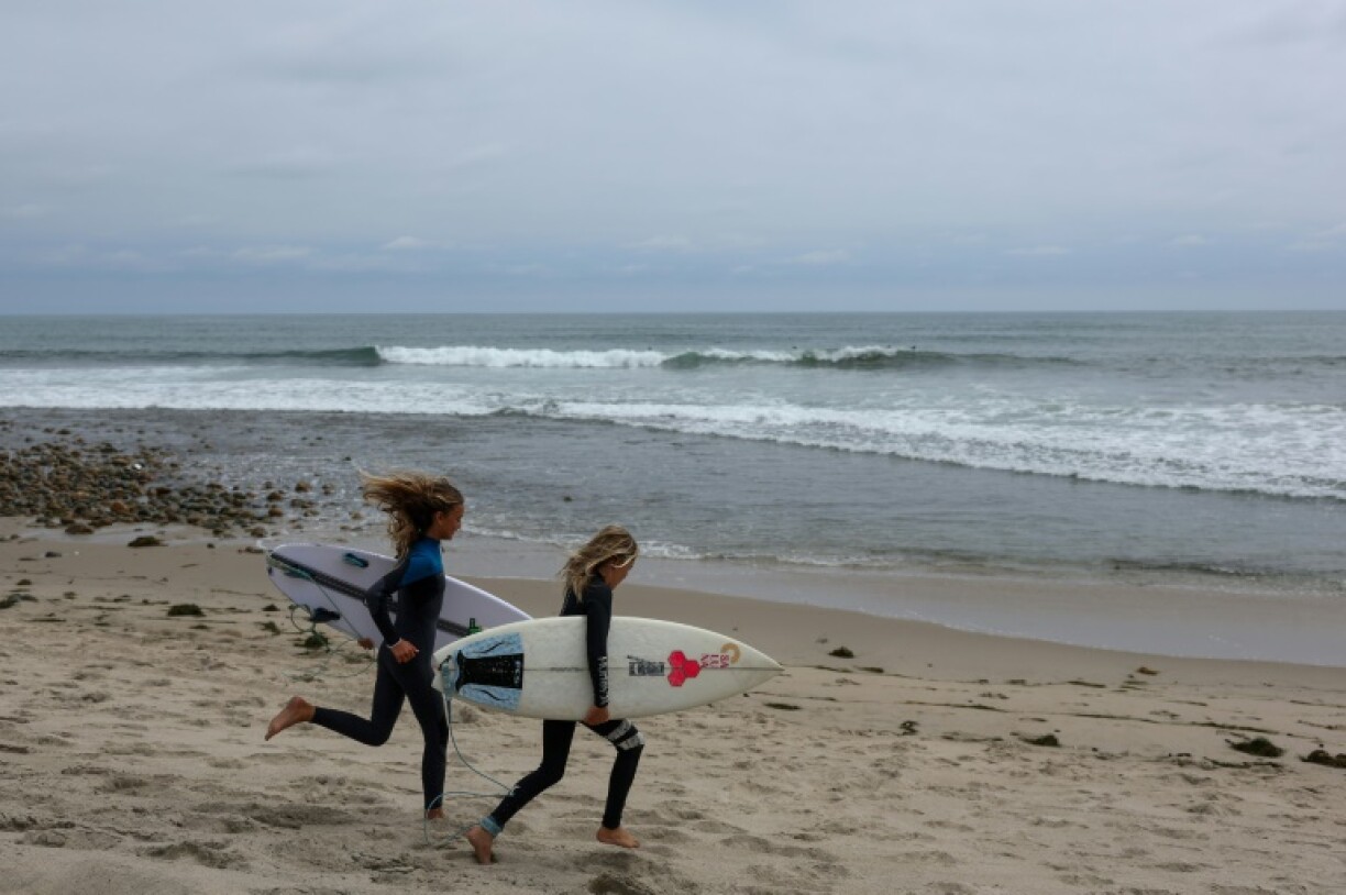 Surfers prepare to enter the Pacific Ocean at Trestles beach in Southern California, which will host the 2028 Olympics surfing competition