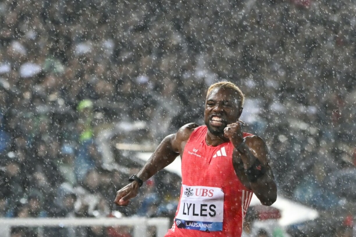 US sprinter Noah Lyles runs under the rain as he competes in the 100m event at the Lausanne Diamond League meet