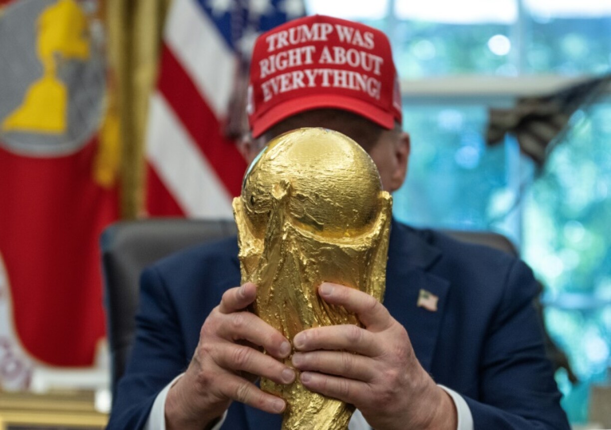 US President Donald Trump holds the World Cup trophy -- he announced the 2026 World Cup draw will be held on December 5, 2025 at Washington's Kennedy Center