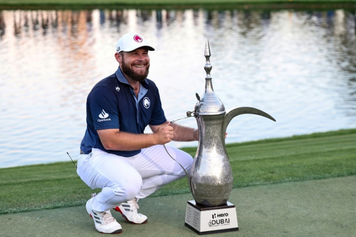 Tyrrell Hatton poses proudly with his Dubai Desert Classic trophy