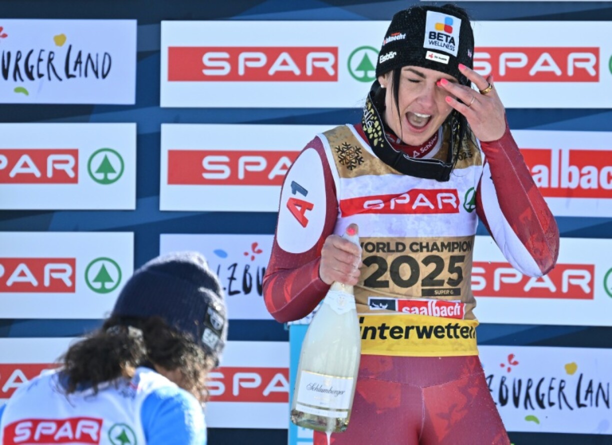 Austria's Stephanie Venier wipes champagne from her eye