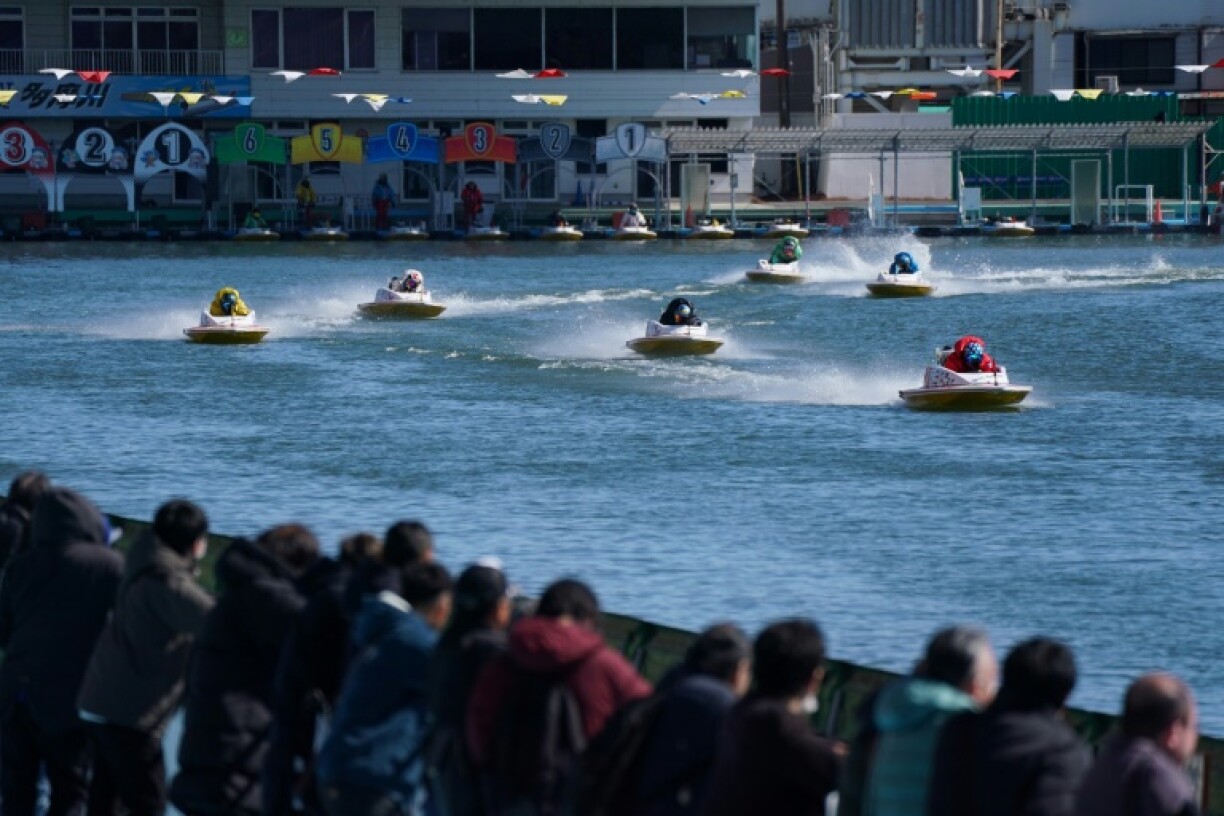 Spectators watch a race at Tokyo's Tamagawa boat course
