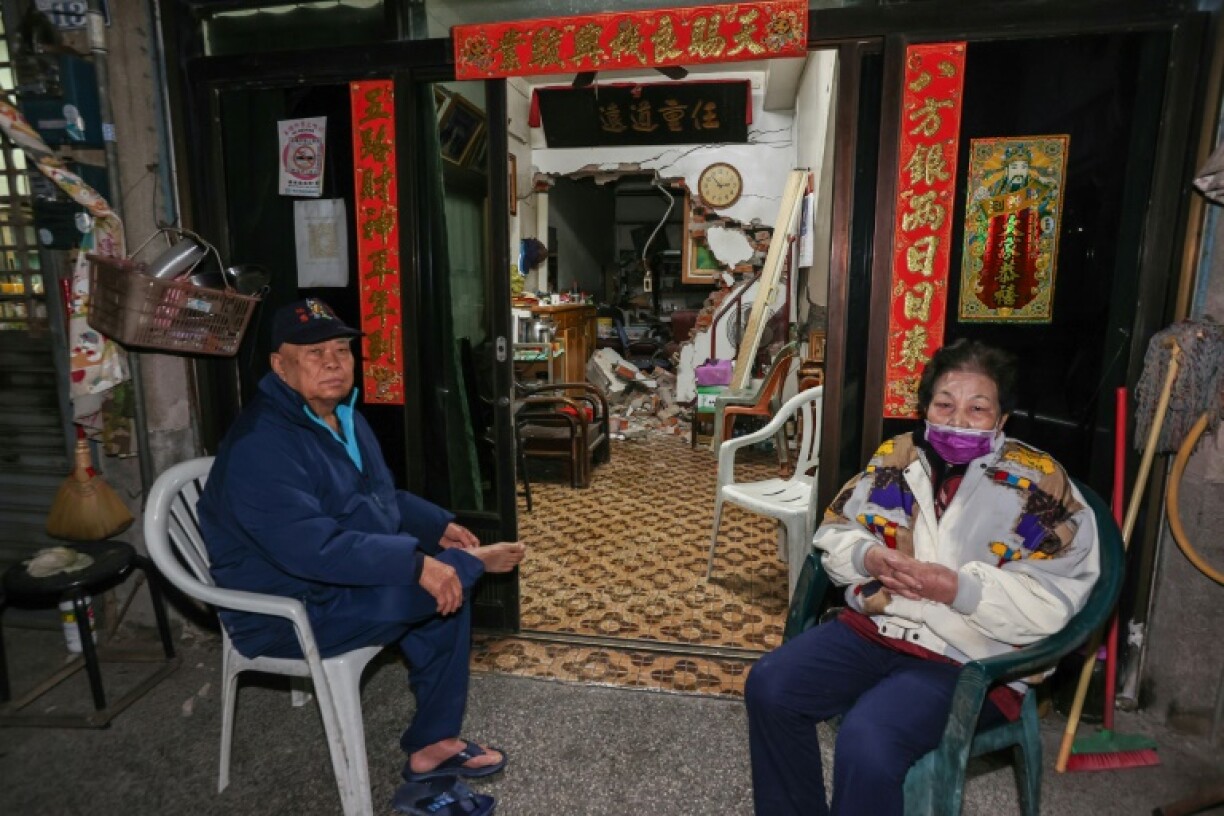 Residents in Tainan outside their damaged home, after an earthquake rattled Taiwan overnight
