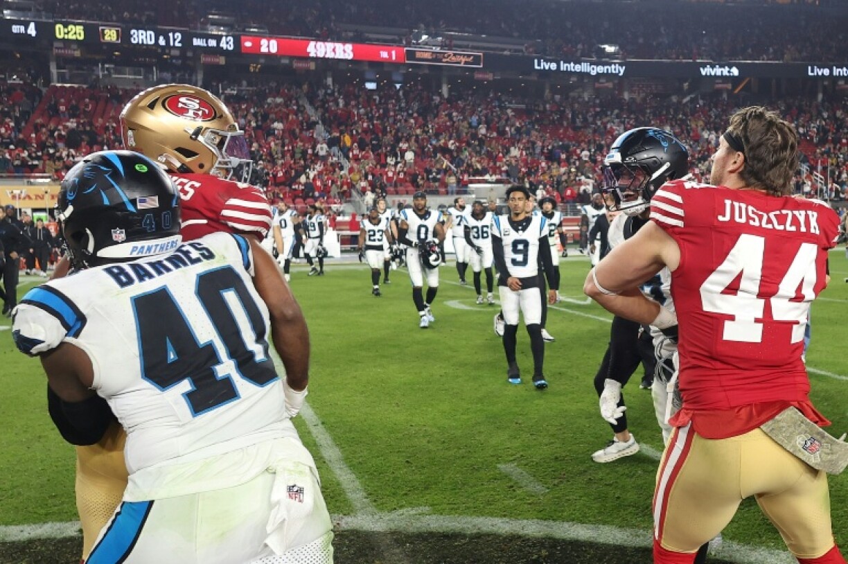 San Francisco's Jauan Jennings, back left, is separated from Carolina's Tre'von Moehrig, back right, after a post-game confrontation that led to Moehrig being issued a one-game ban by the NFL for an earlier punch to the groin of Jennings