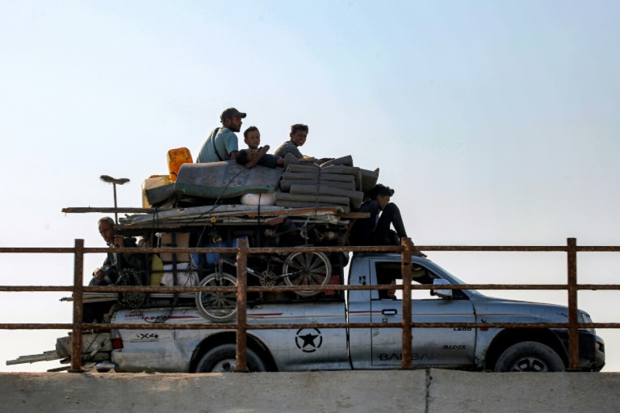 Displaced Gazans head south along a coastal road as the Israeli military gears up for a major new operation in the territory's north