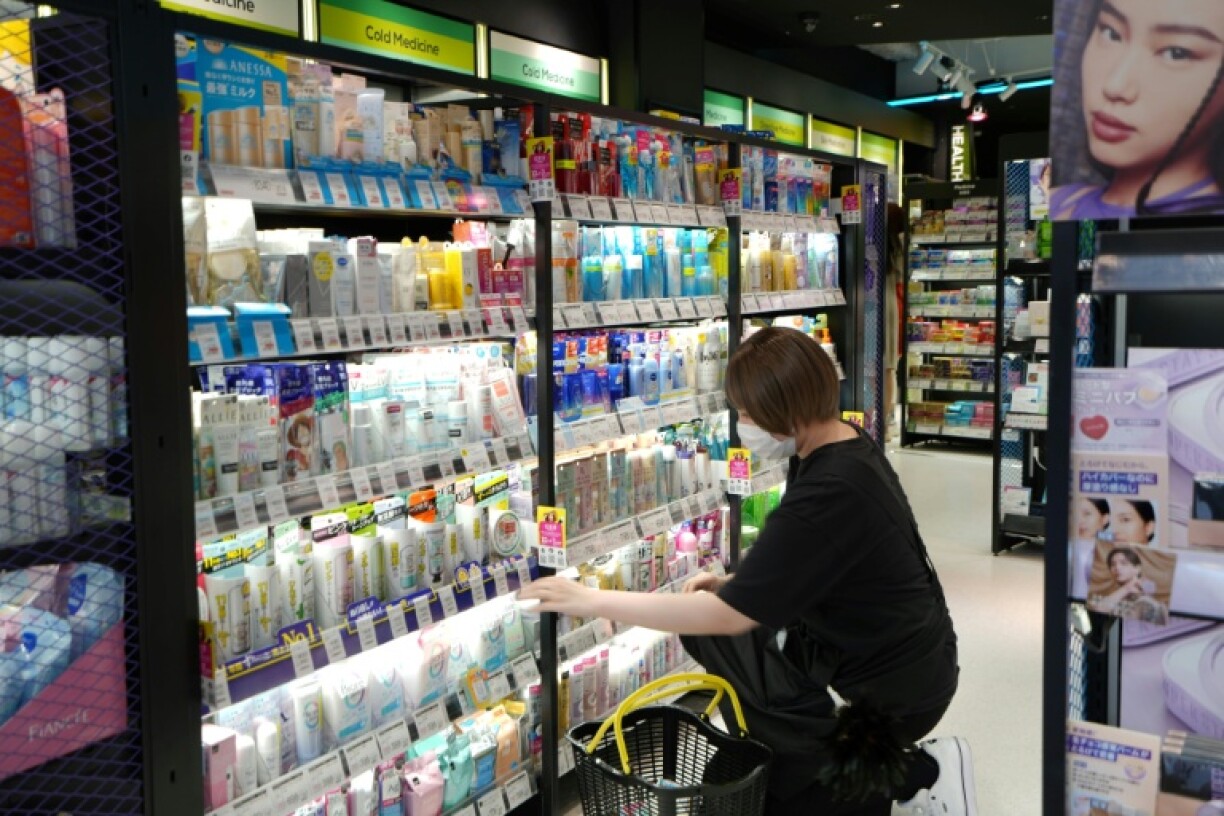 A shopper browses for sun screen products in a store in Tokyo's Shibuya district