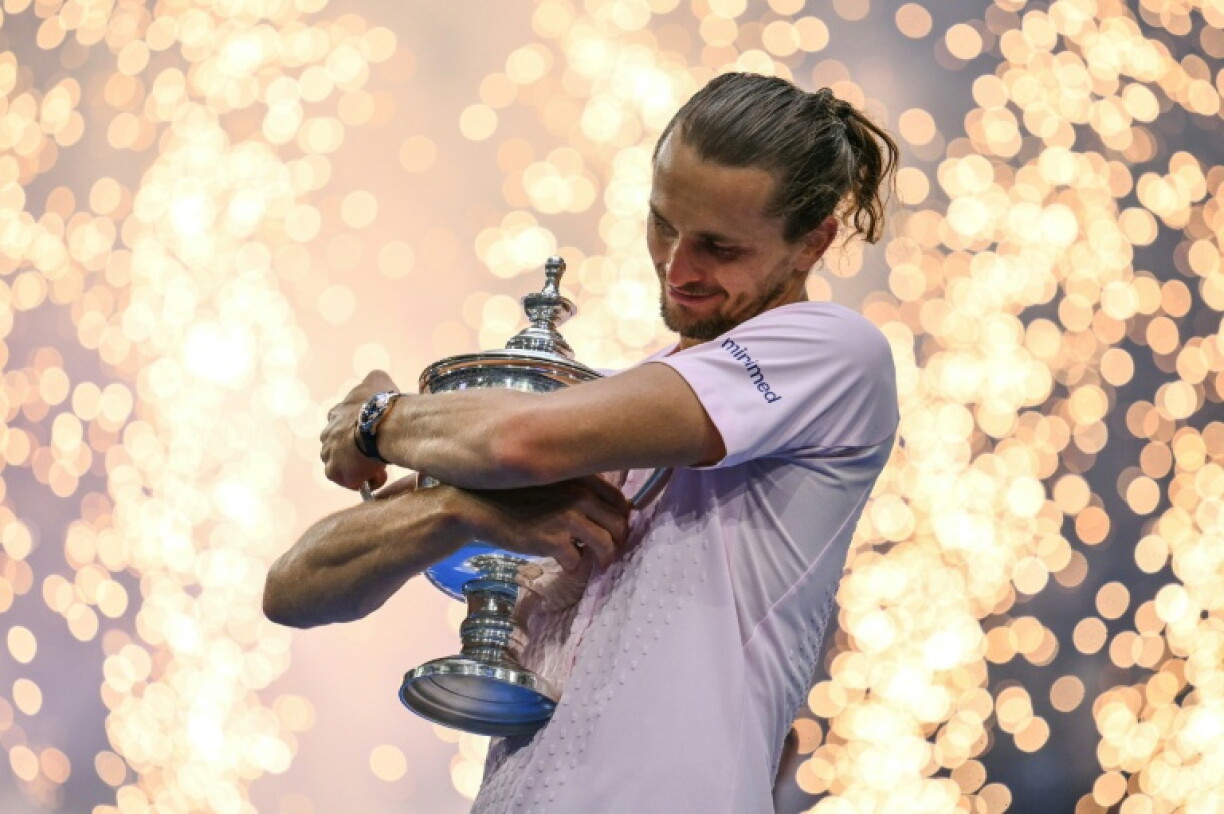 Alexander Zverev hugs the trophy after winning the US Open