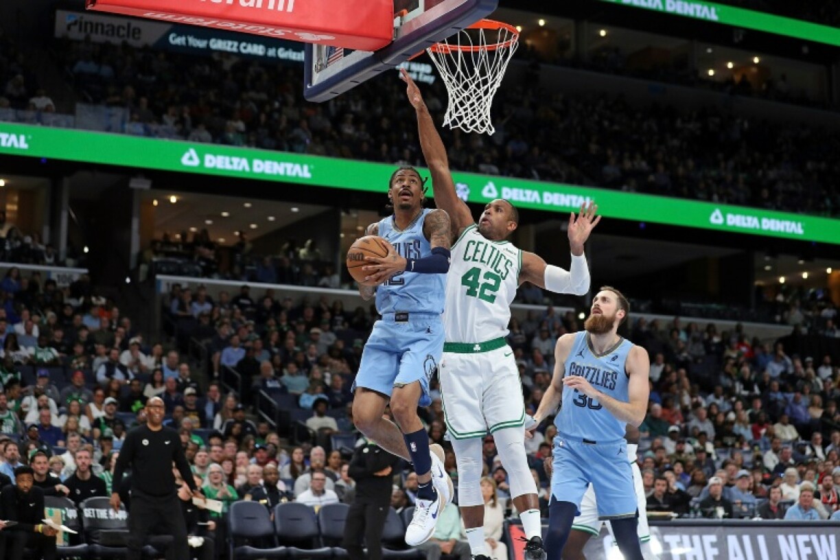 Memphis star Ja Morant goes to the basket challenged by Al Horford of the Boston Celtics in the Celtics' NBA victory over the Grizzlies