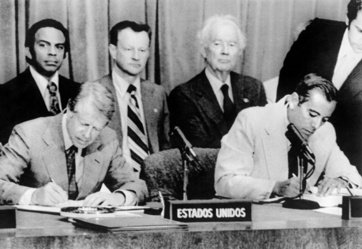 US president Jimmy Carter (L) and General Omar Torrijos of Panama (R) sign the ratified Panama Canal treaties in June 1977 in Panama City; they initially signed the deals a year earlier