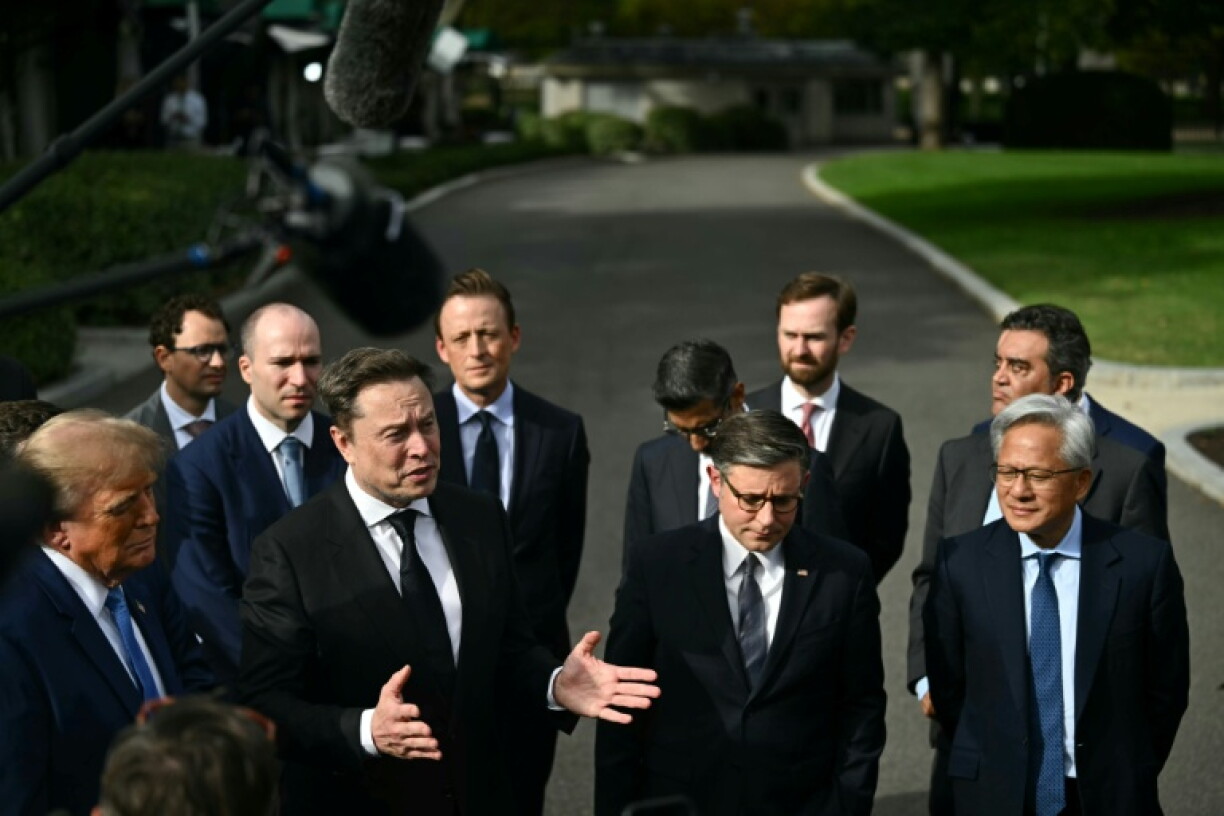 SpaceX CEO Elon Musk speaks to the press next to US President Donald Trump, House Speaker Mike Johanson and Nvidia CE Jensen Huang after a meeting about artificial intelligence at the White House