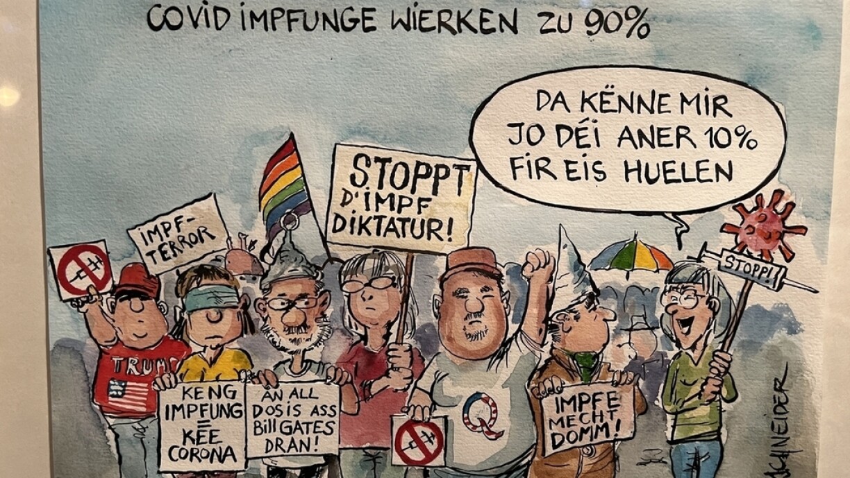 E Cartoon vum Carlo Schneider. D'Bild hänkt an der Ausstellung