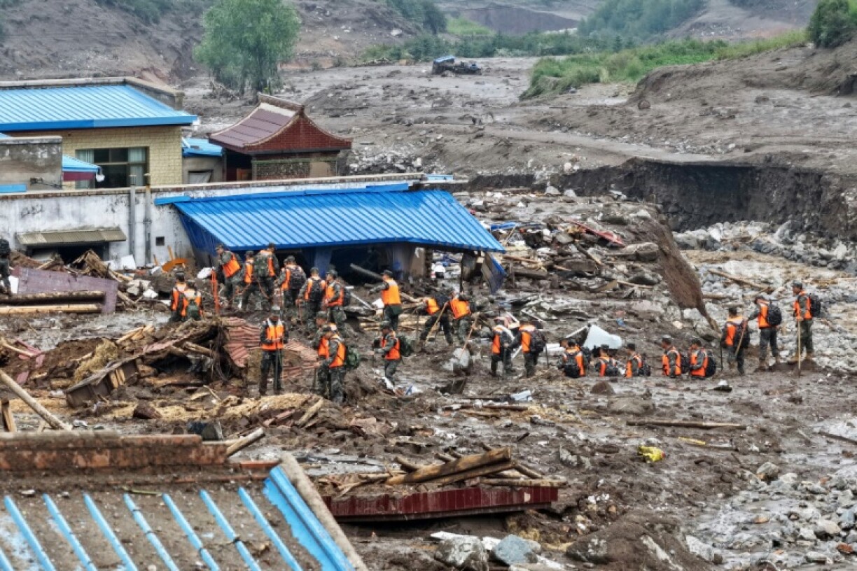 The death toll from flash floods and mudslides in China's northwestern Gansu has risen to 13, with 30 people missing, state media said